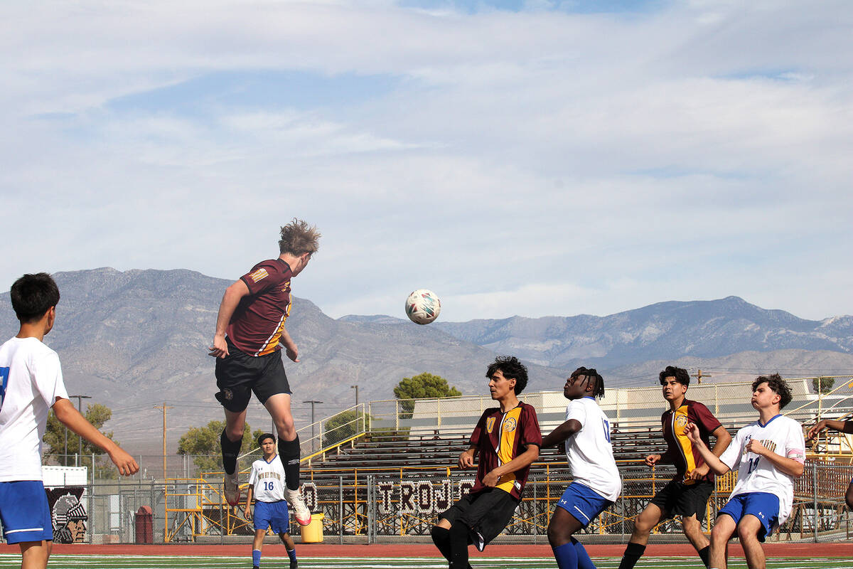 PVHS junior midfielder TC Hone tries to get a header on the ball during a corner kick in a Clas ...
