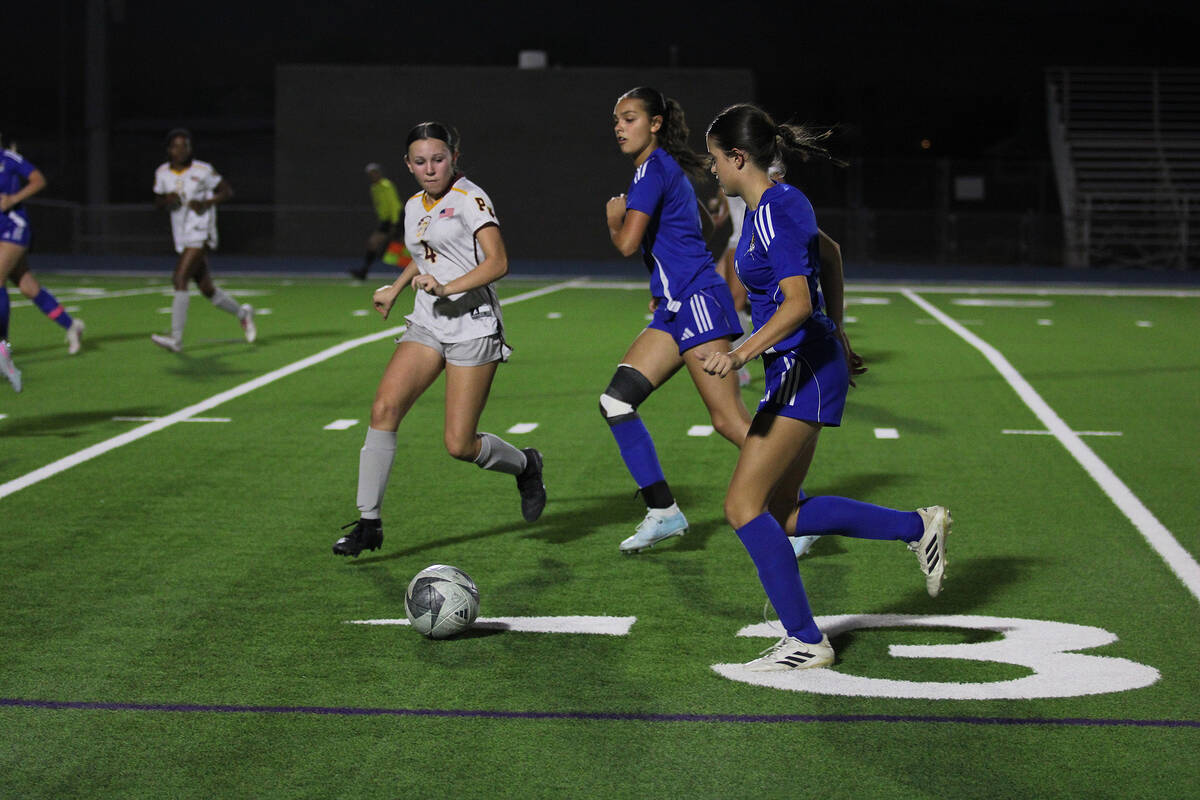 PVHS girls soccer freshman Raylee Smith tries to take on two Moapa Valley attackers during the ...