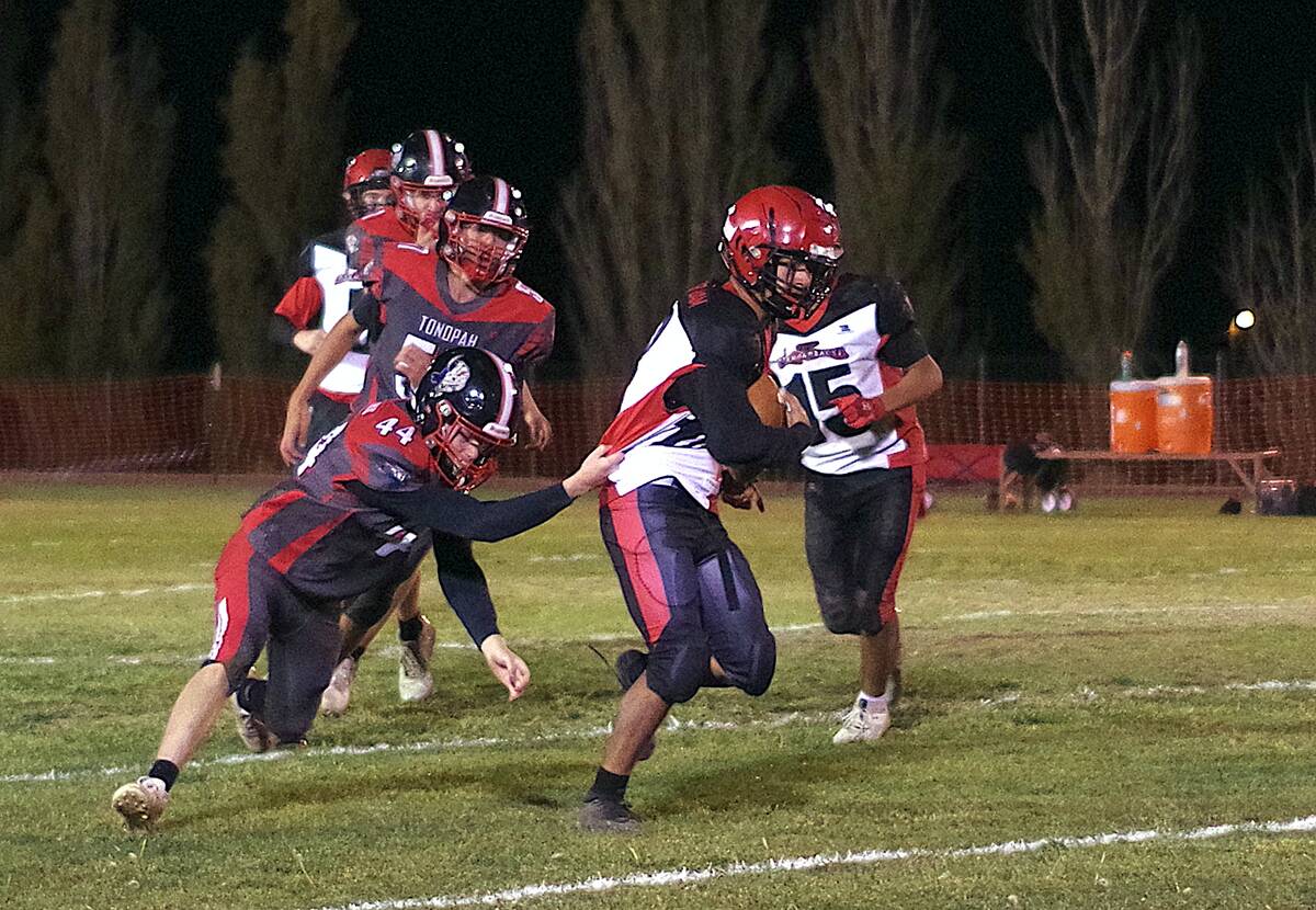 Tonopah Muckers OL/DL junior Jesse Cannizzaro attempts to make a tackle on a Beaver Dam running ...
