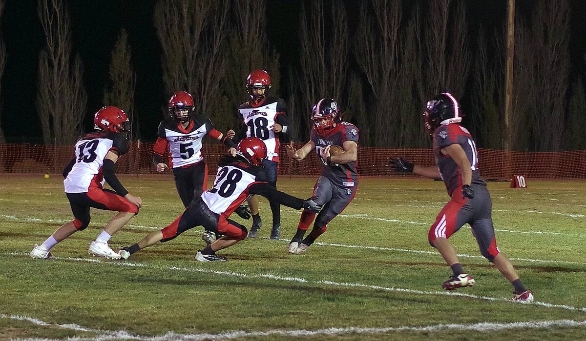 Tonopah Muckers junior RB/LB Dustin Otteson cuts back on the line to avoid Beaver Dam defender ...