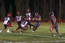 Tonopah Muckers junior RB/LB Dustin Otteson cuts back on the line to avoid Beaver Dam defender ...