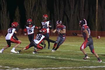 Tonopah Muckers junior RB/LB Dustin Otteson cuts back on the line to avoid Beaver Dam defender ...