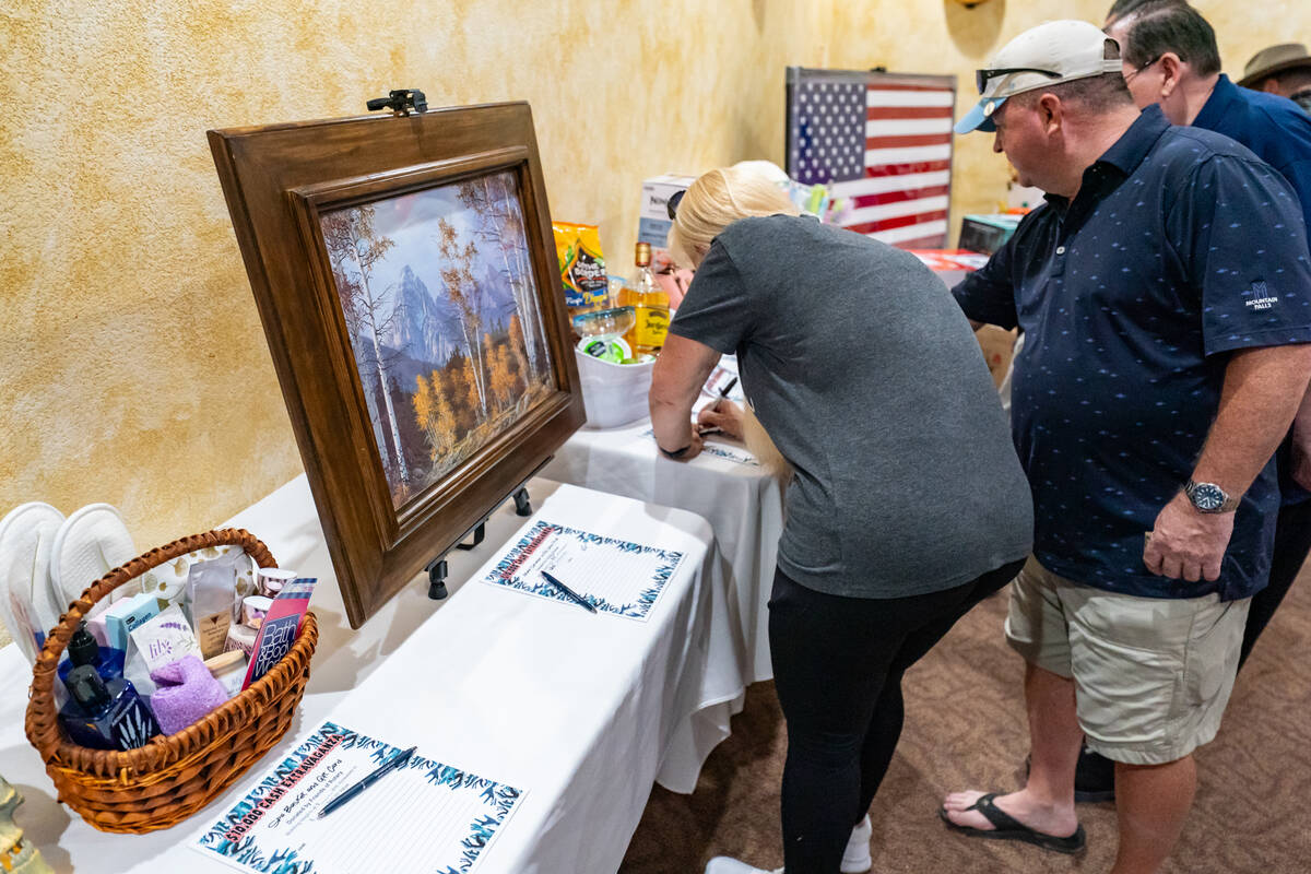 Attendees check out items in the silent auction. (John Clausen/Pahrump Valley Times)