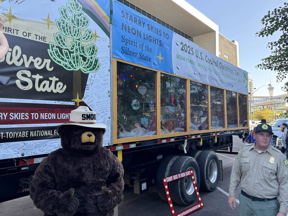 Smokey Bear and his U.S. Forest ranger friend readied for selfies with Silver Belle and a crowd ...