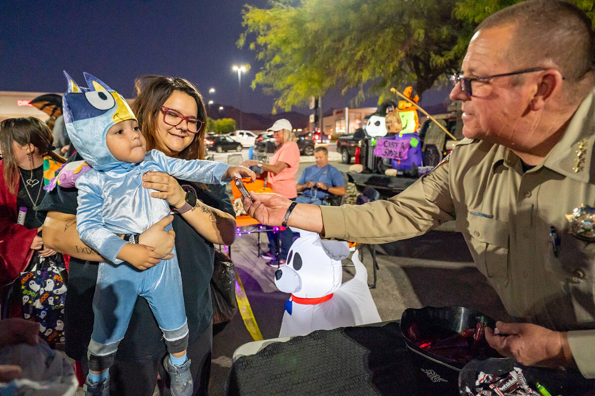 Nye County Sheriff Joe McGill handed out candy to Pahrump youngsters at the Smith’s trunk-or- ...