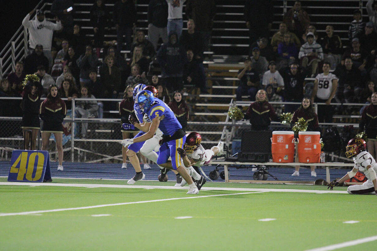 Moapa Valley High School senior wideout Caden Rawson breaks a huge tackle in double coverage fo ...