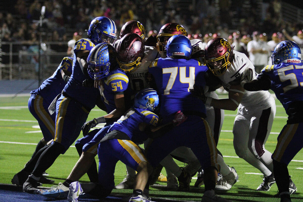 The Trojans offense runs a successful inside handoff powered by the offensively line at the Pir ...