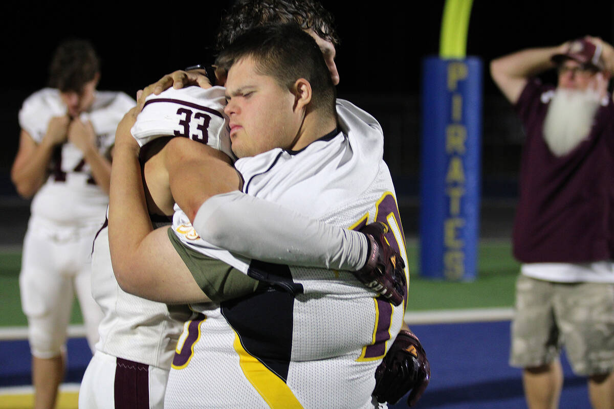 PVHS senior captain Austin Alvarez gives his team manager Noah Boruchowitz a big hug as the Tro ...
