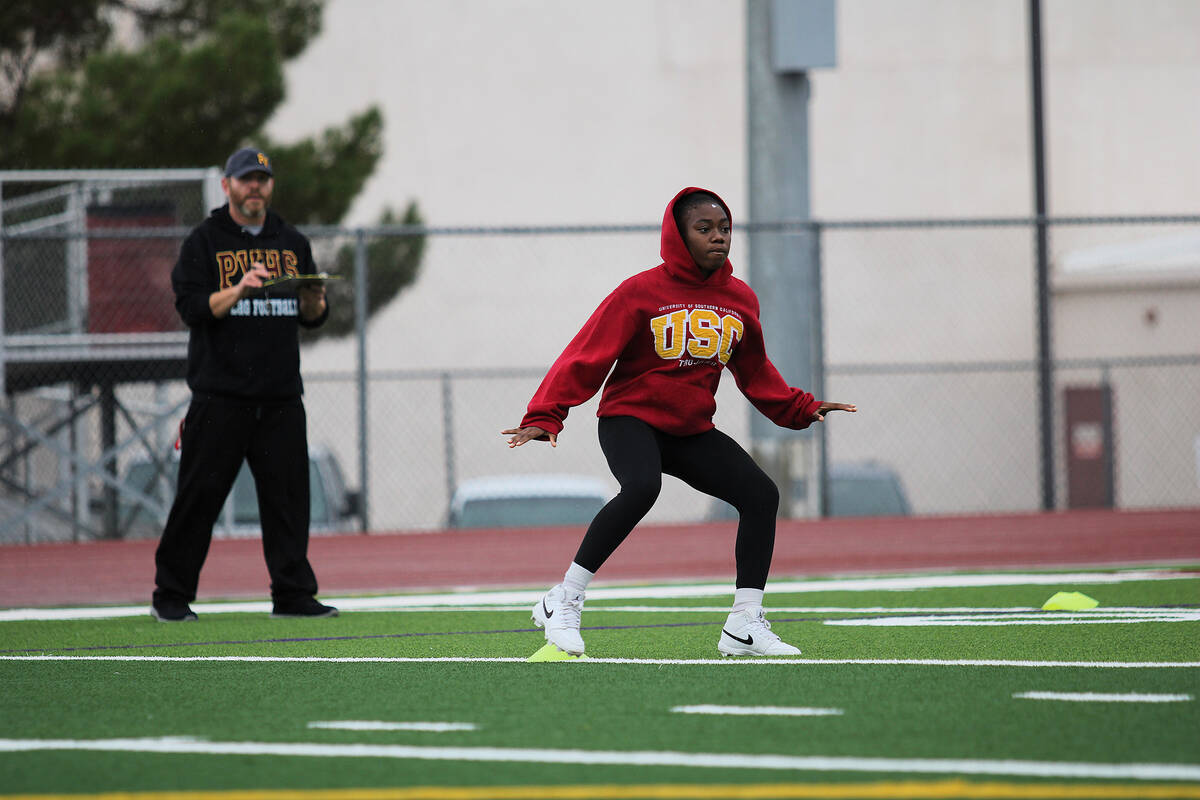 Pahrump Valley High School girls flag football player Ma'liyah Collins runs drills with head co ...