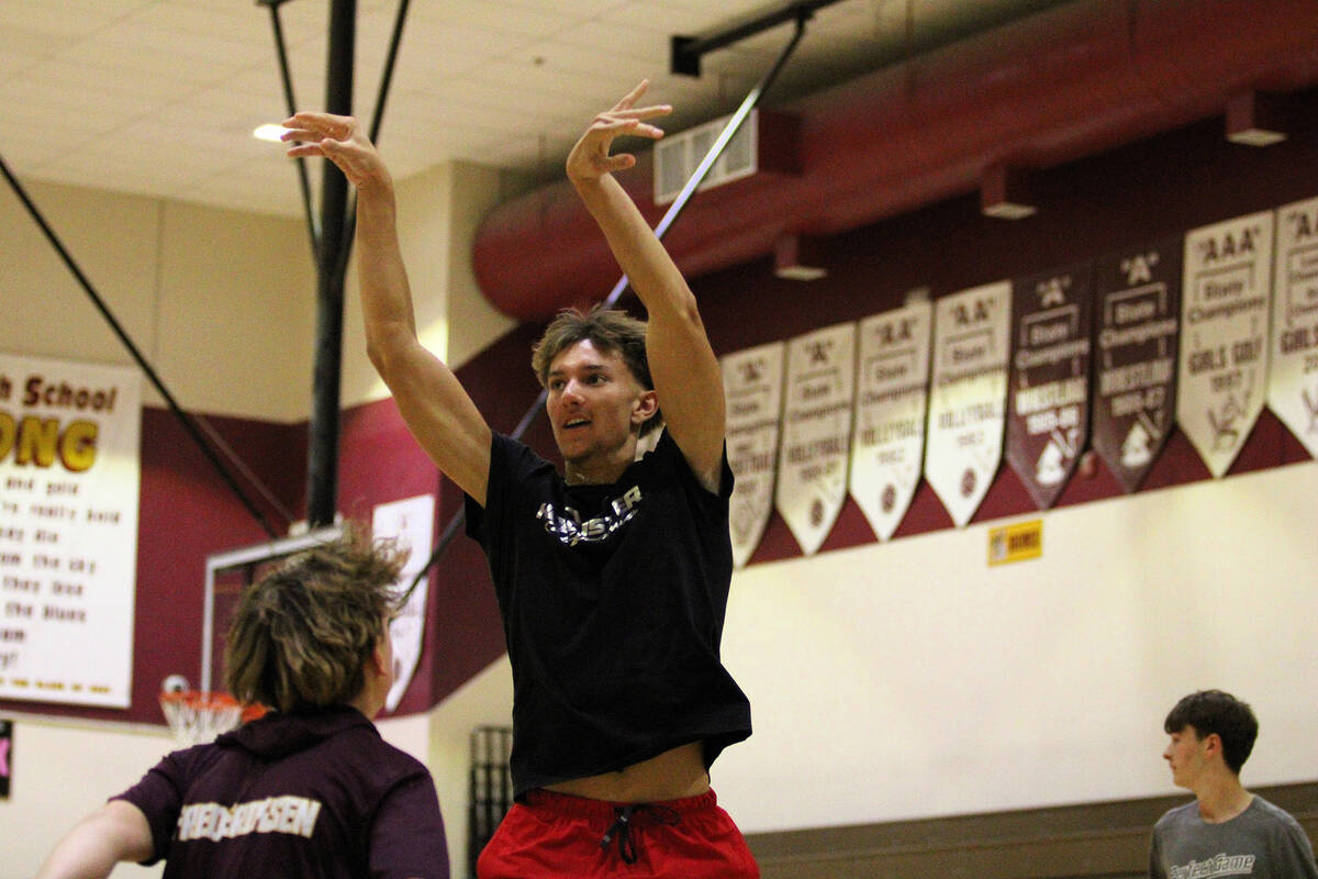 PVHS athlete senior Aydon Veloz releases a shot over his defender during the Trojans basketball ...