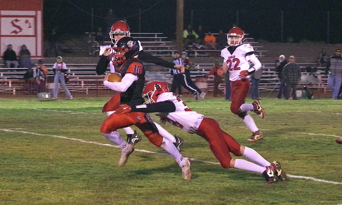 Tonopah High School junior Dustin Otteson sheds a Carlin defender as he makes his way toward th ...