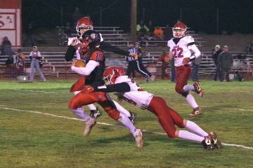 Tonopah High School junior Dustin Otteson sheds a Carlin defender as he makes his way toward th ...