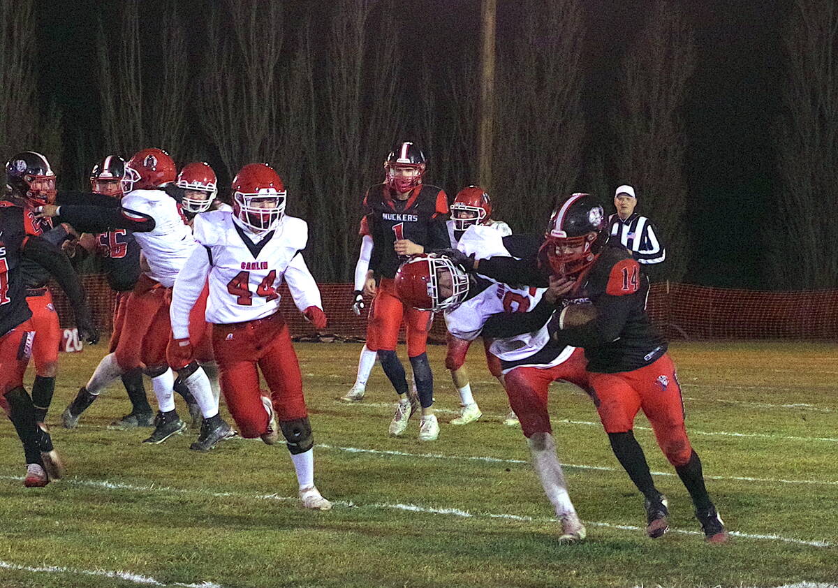 Tonopah High School senior Adelaido Salgado breaks a tackle against a Carlin defender during th ...