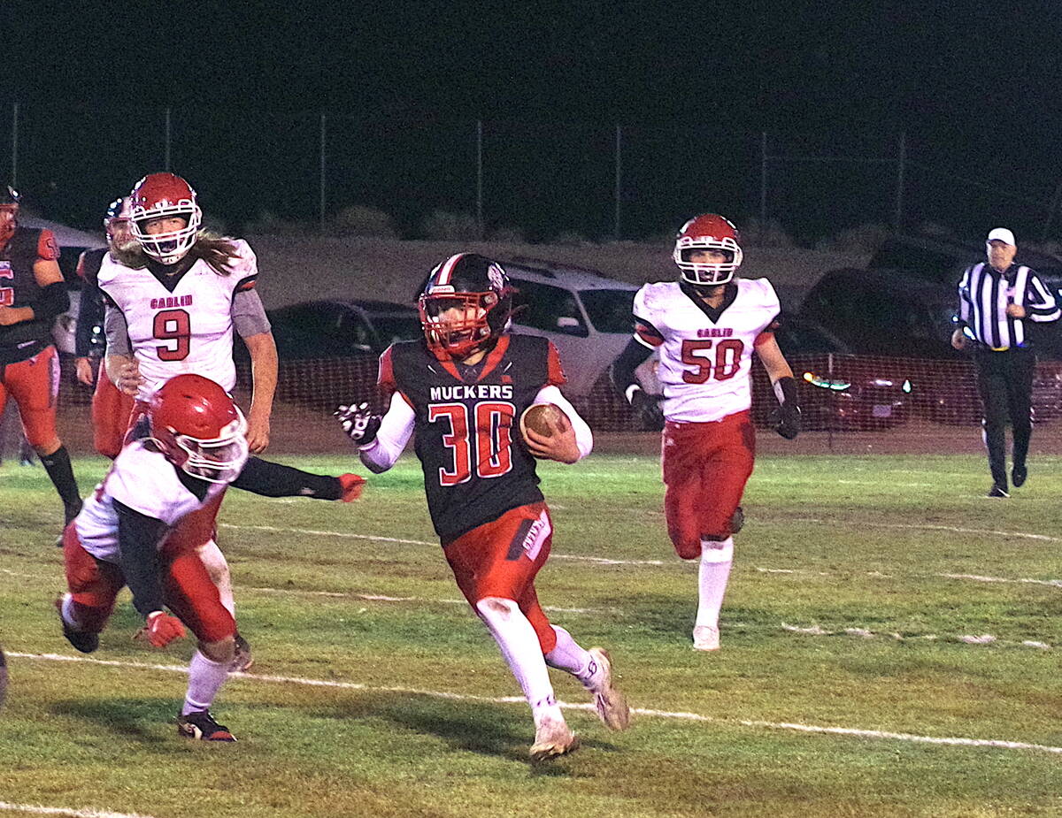 Tonopah High School junior Dustin Otteson looses a Carlin defender during the Muckers Class 1A ...