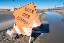 Bright orange signs notifying drivers of water on local roadways are still in place throughout ...
