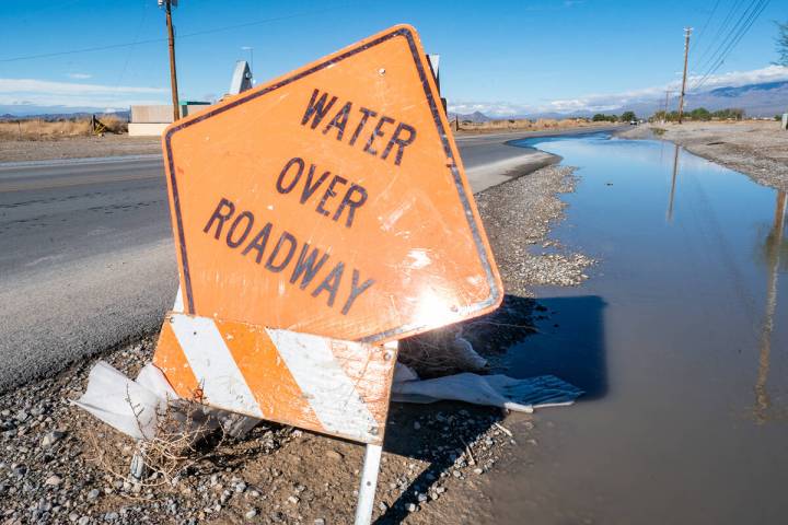 Bright orange signs notifying drivers of water on local roadways are still in place throughout ...