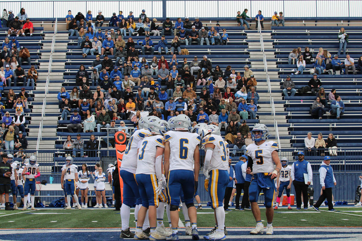 Backed by nearly 400 traveling fans from Alamo, Pahranagat Valley High School huddles to strate ...