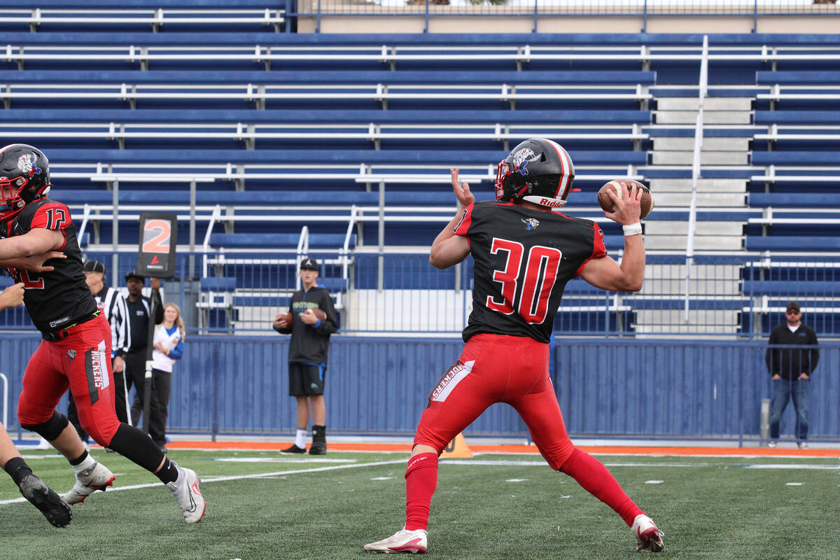Tonopah High School junior quarterback attempts to throw the ball downfield deep during the Cla ...