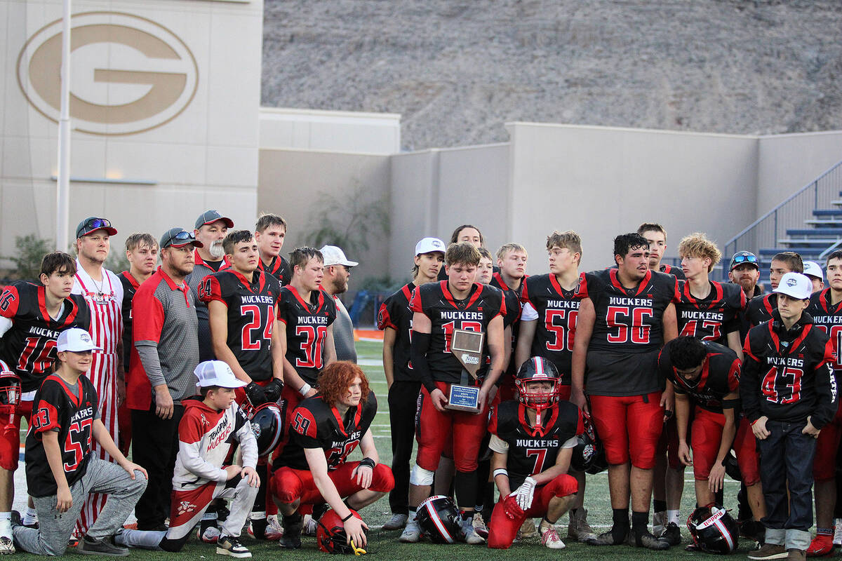 The Tonopah Muckers hold up their Class 1A state title runner-up trophy as they fell to Pahrana ...