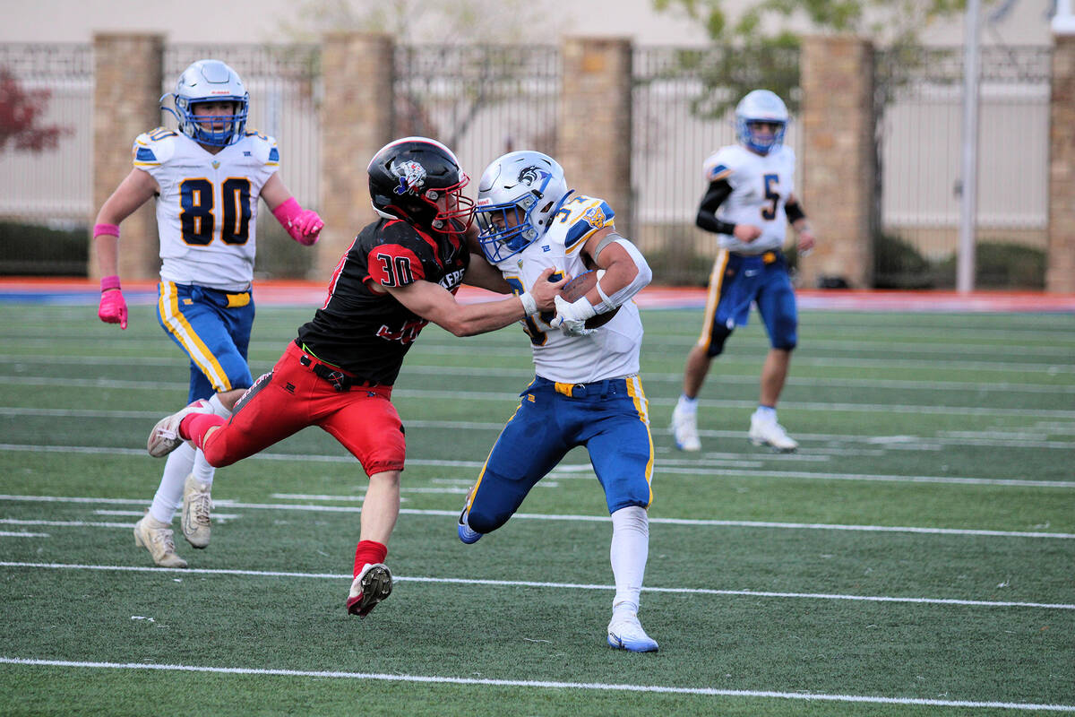 Tonopah High School junior Dustin Otteson attempts to bring down Pahranagat Valley senior TE/DE ...