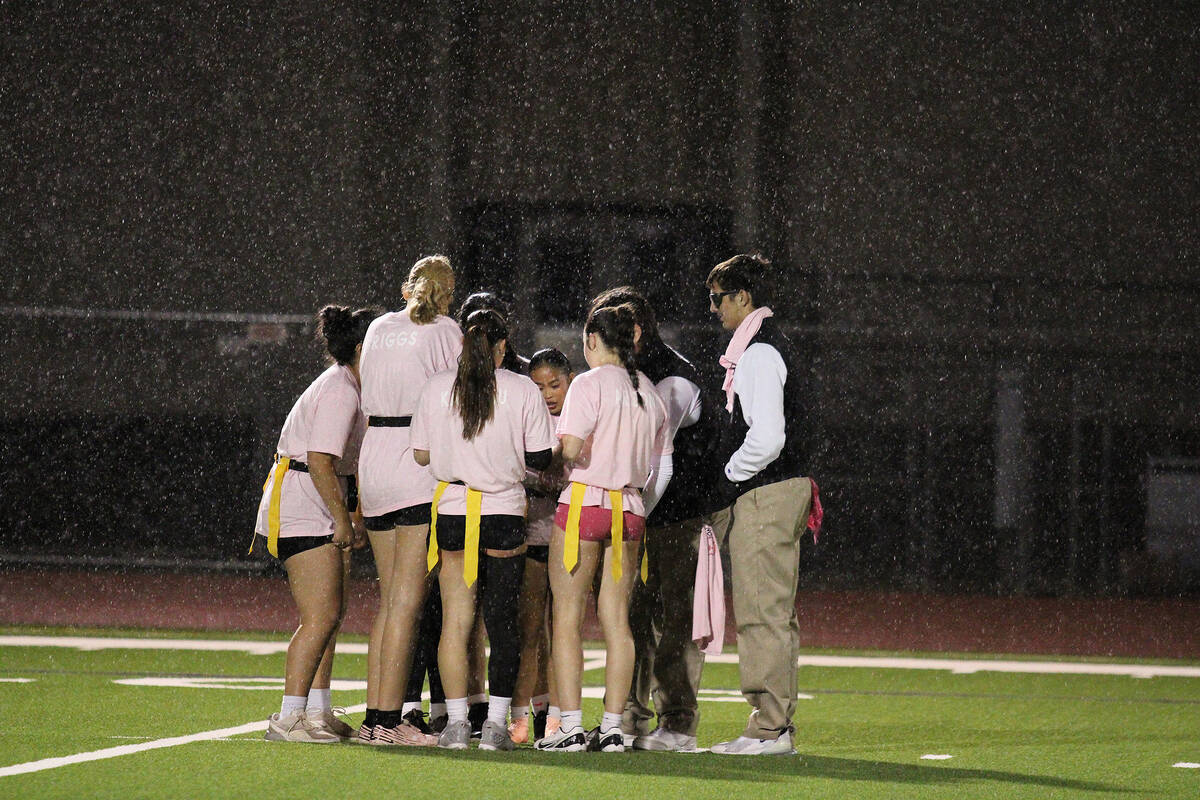The Pink Panthers take team timeout to review a play while the downpour of heavy winter rain sh ...