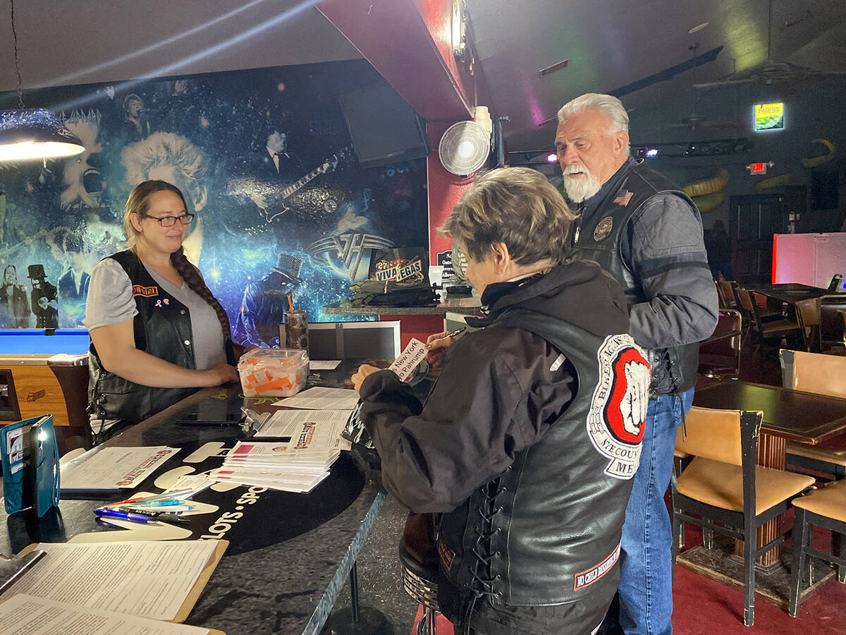 Registrants for the Bikers Against Bullying Turkey Trot sign in for the event the morning of Sa ...