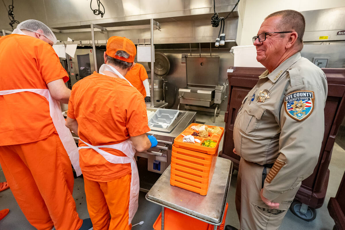 Sheriff Joe McGill oversees inmate workers prepare and stack trays with Thanksgiving dinner for ...