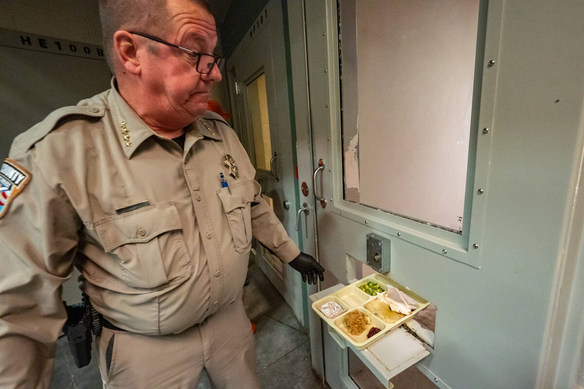 Sheriff McGill hands out the dinner trays to those inmates held in their cell. Some prisoners a ...