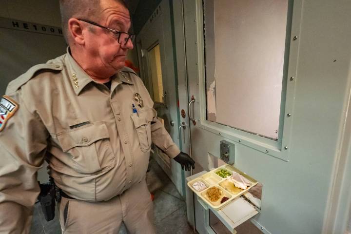 Sheriff McGill hands out the dinner trays to those inmates held in their cell. Some prisoners a ...