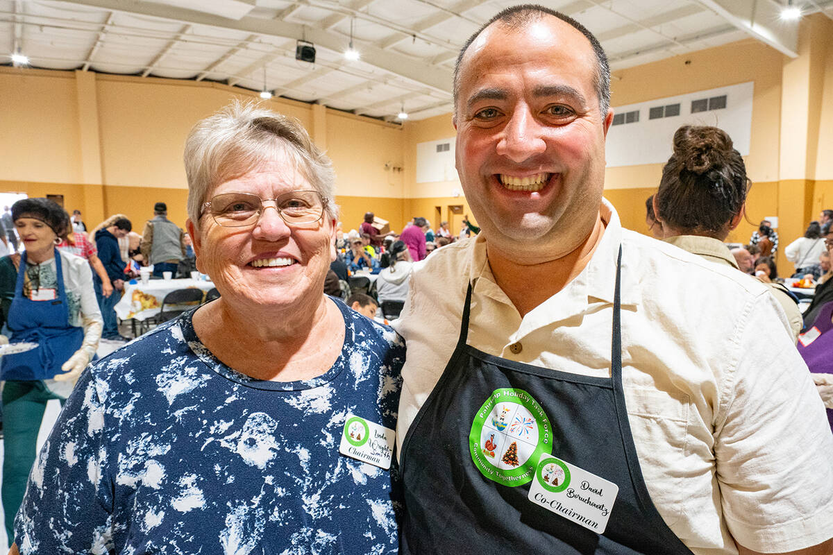 Pahrump Holiday Task Force leads Linda Wright-Smith and David Boruchowitz pause for a quick pho ...