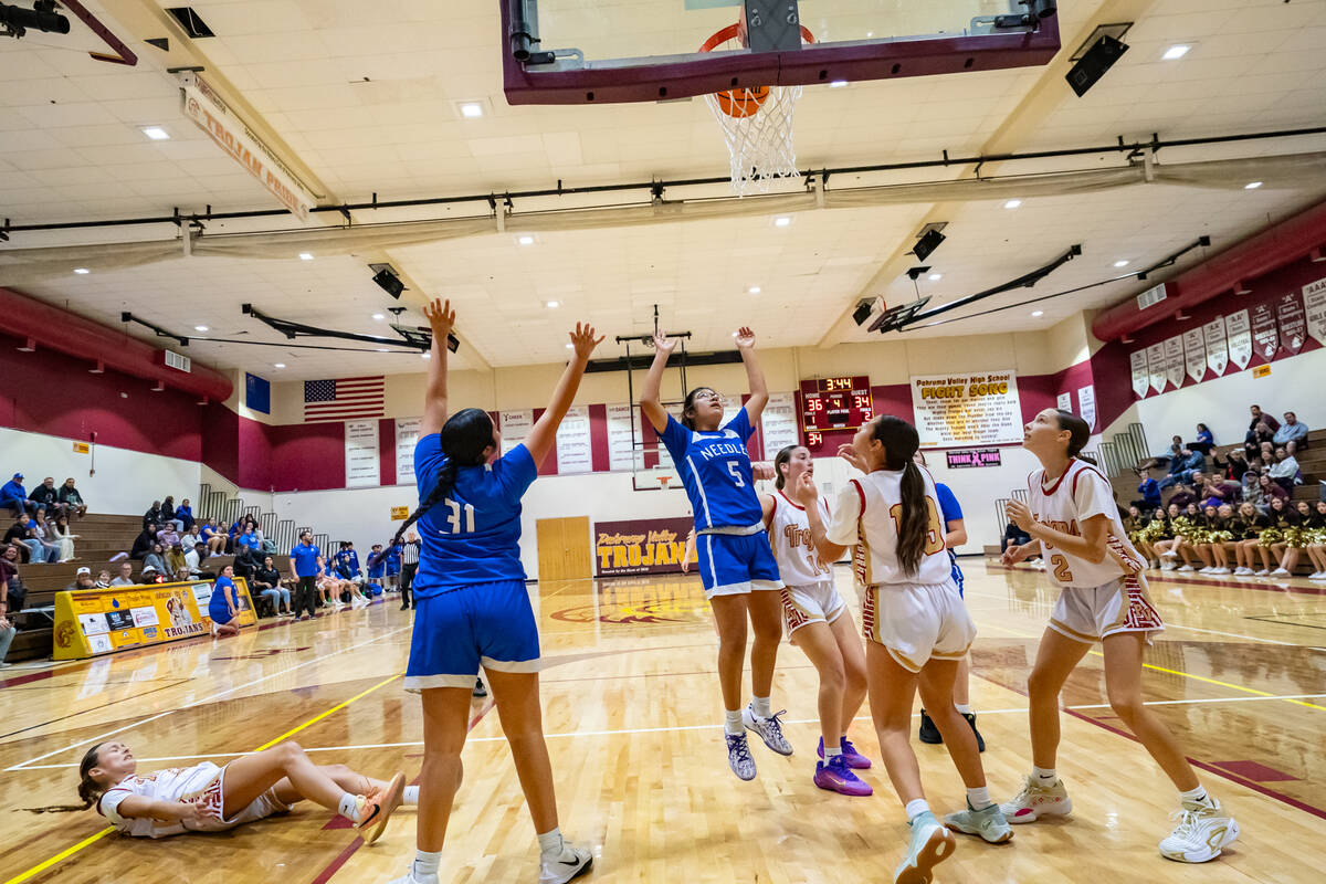 Pahrump Valley High School varsity girls basketball junior point guard Riley Saldana follows th ...