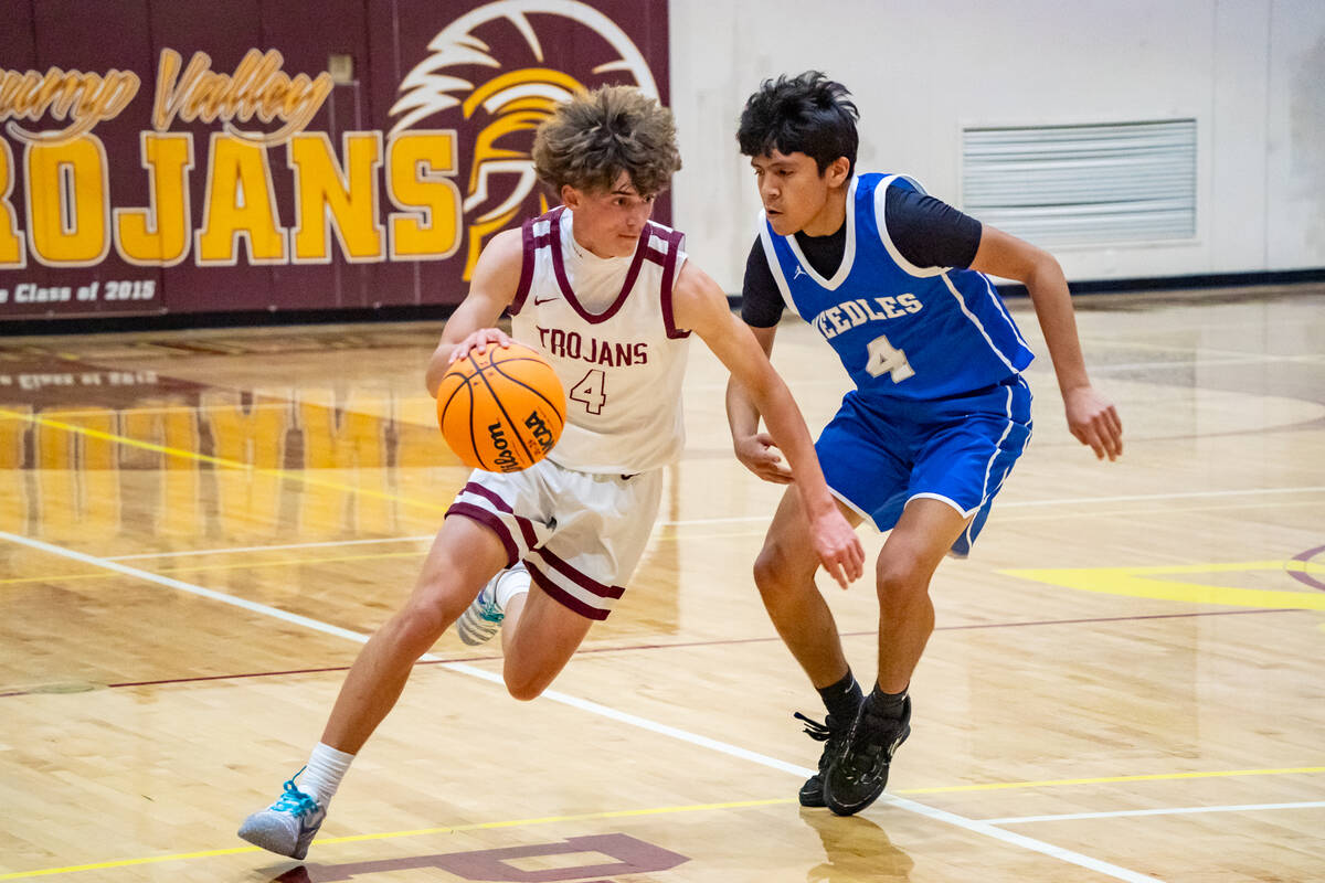 Pahrump Valley High School senior guard Kier Sheppard advances the ball down the baseline of th ...