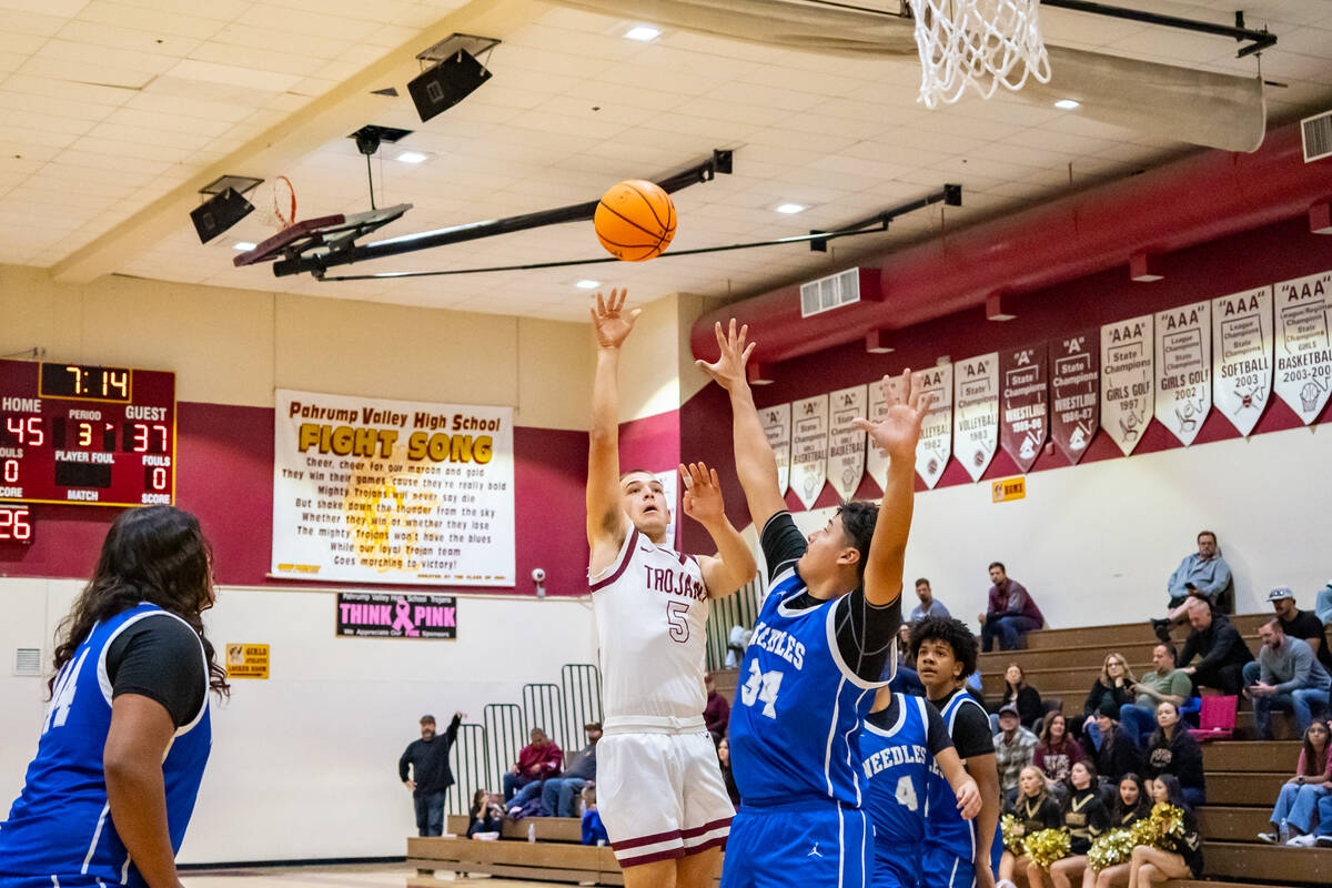 Pahrump Valley High School senior forward Joshua Slusher is fouled on his jump shot attempt by ...