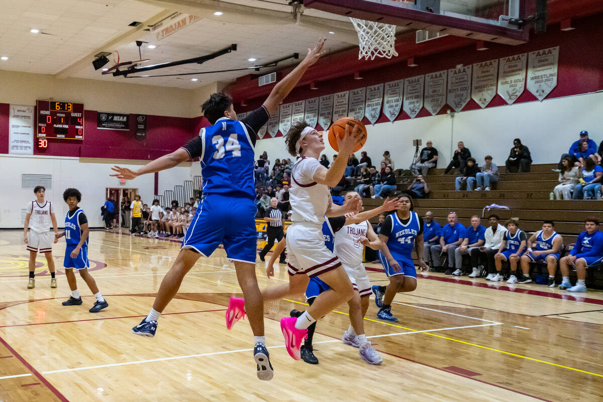 Pahrump Valley High School senior junior forward Lucas Gavenda drives in for a layup against Ne ...