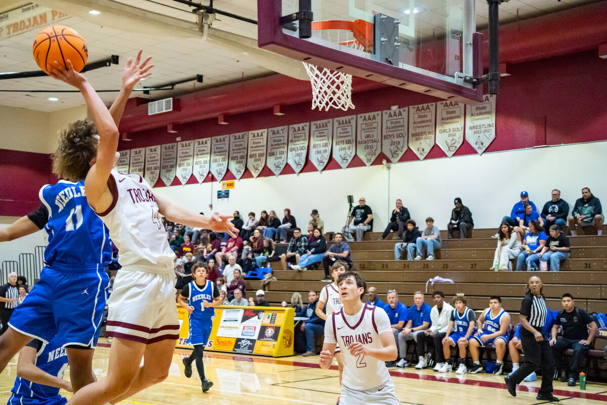 Pahrump Valley High School senior guard Kier Sheppard jolts past Needles senior guard Milton De ...