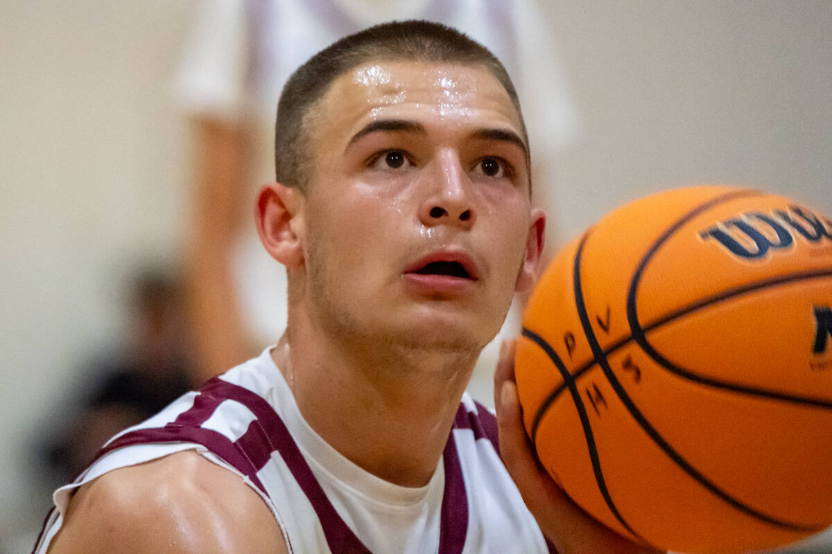 Pahrump Valley High School senior forward Joshua Slusher tunes out the crowd noise to lock in a ...