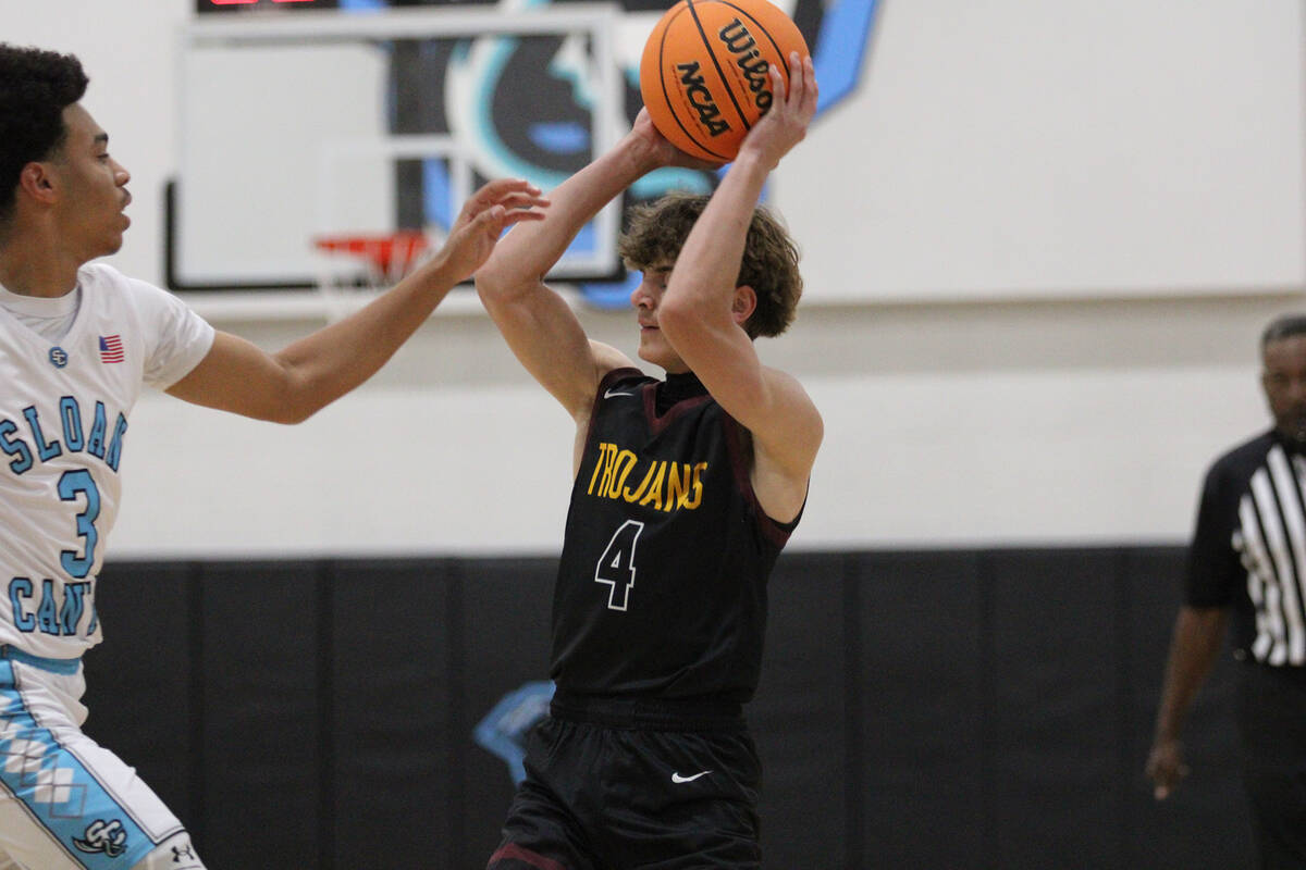 Pahrump Valley High School senior guard Kier Sheppard looks to get rid of the ball after receiv ...