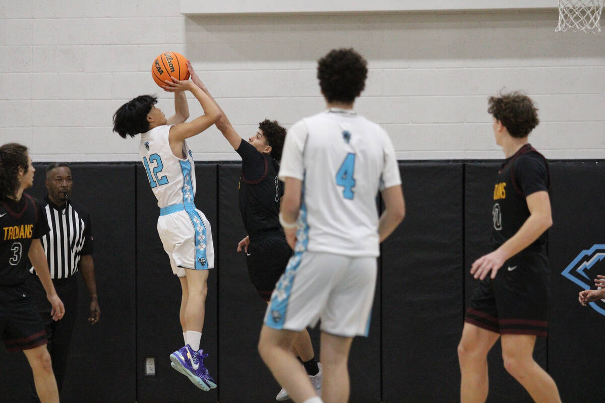 Pahrump Valley High School junior Trae Plein blocks a Pinecrest Academy Sloan Canyon point guar ...