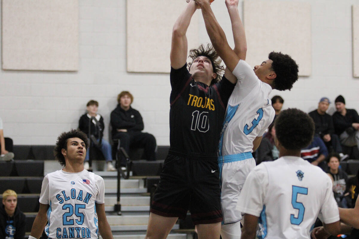Pahrump Valley High School junior guard Lucas Gavenda fights for the tip-off against Sloan Cany ...