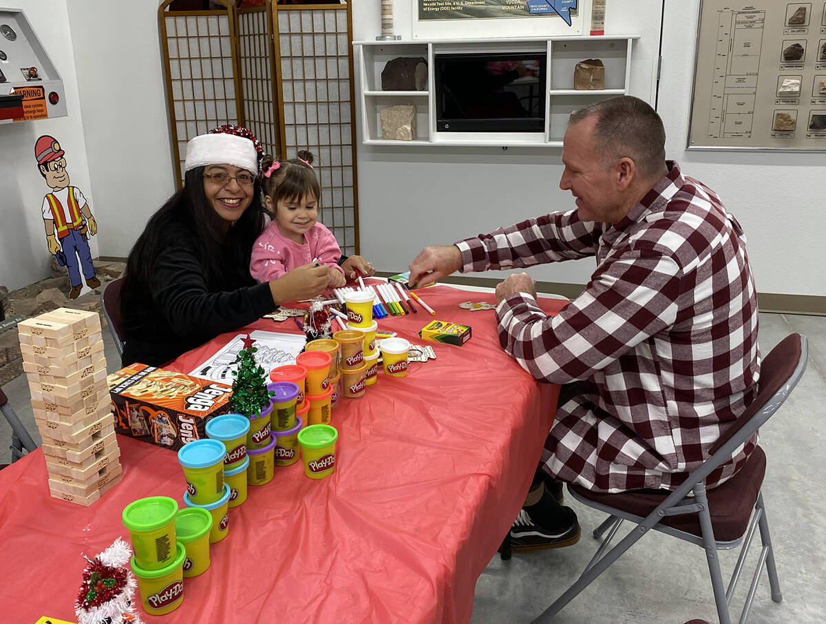 A holiday crafting table arrayed with coloring implements, play dough and more was set up for c ...
