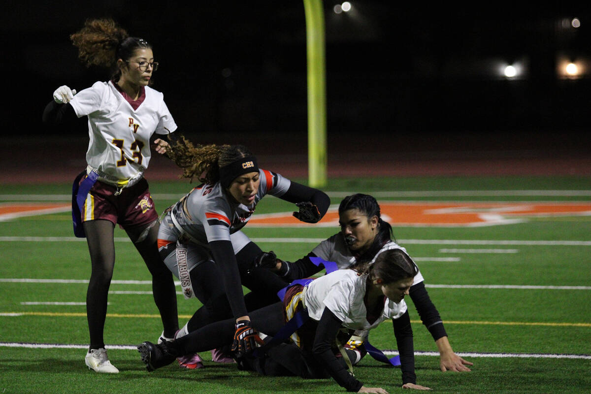 A trio of Pahrump Valley High School defenders pounce on a Cowboy running for daylight in the T ...