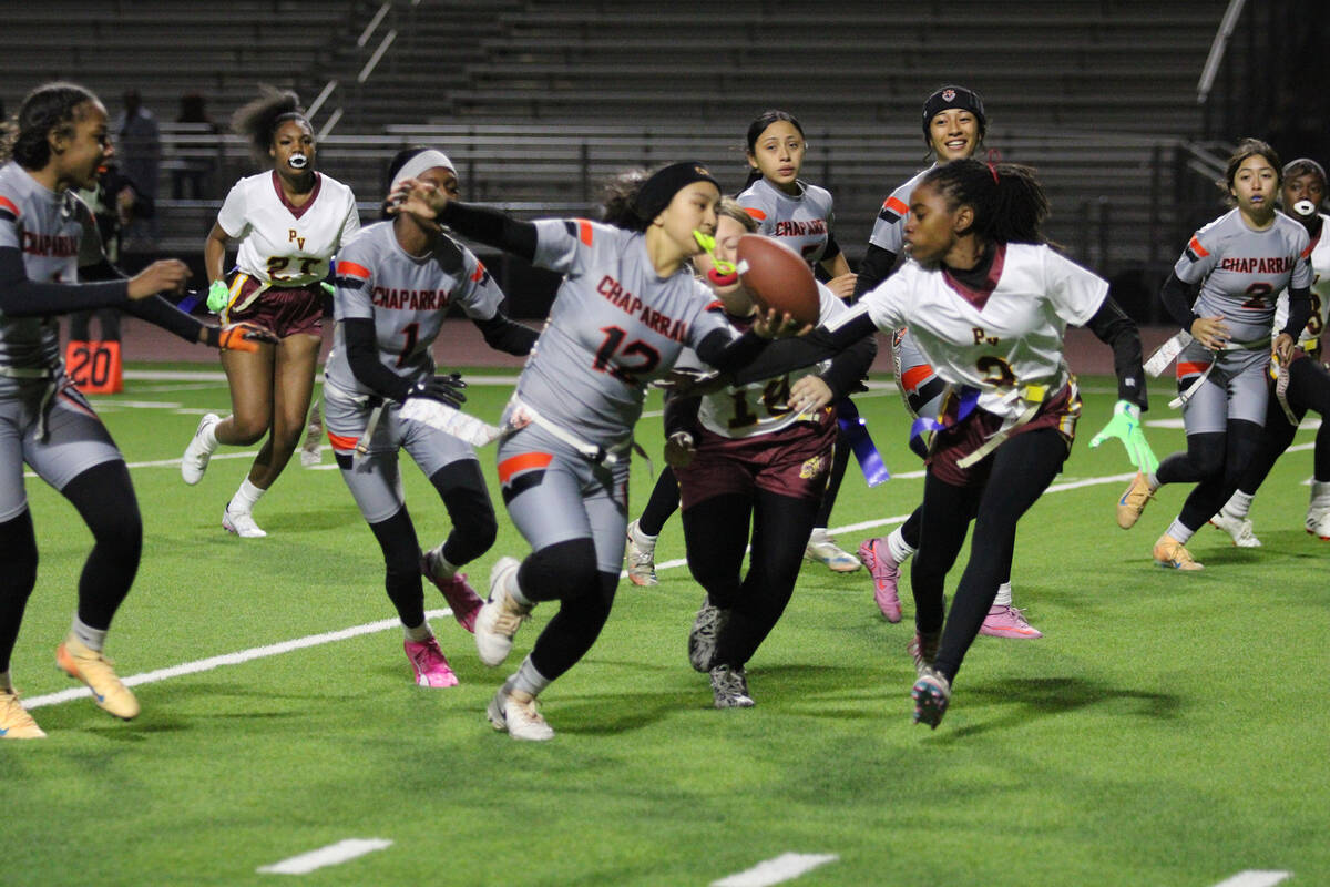 Pahrump Valley High School senior Diona Nixon tries to pull a flag from under a cowboys rusher ...