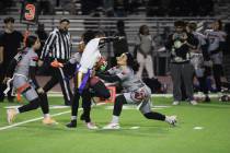 Pahrump Valley High School senior Diona Nixon tries to avoid her flag being pulled during a rus ...