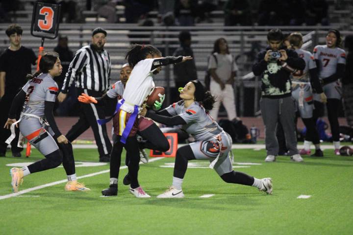 Pahrump Valley High School senior Diona Nixon tries to avoid her flag being pulled during a rus ...