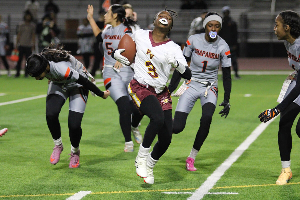 Pahrump Valley High School freshman wideout Ma'liyah Collins tries to avoid a cowboys defender ...