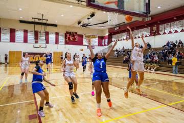 Pahrump Valley High School junior Riley Saldana drive in for a layup against Coral Academy of S ...