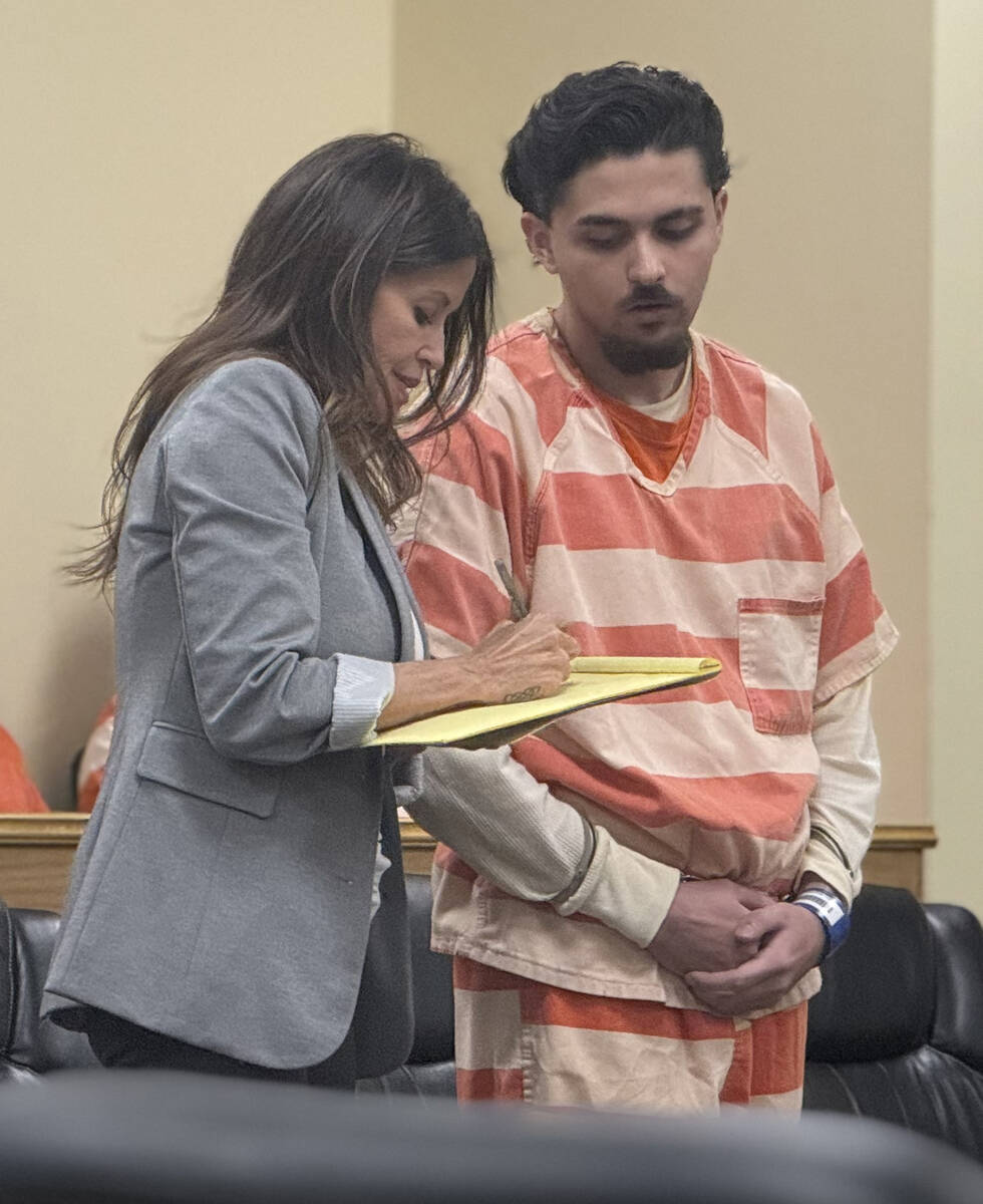 Attorney Ava Bravo consults with her client Fabian Ferrante as the own recognizance release dea ...