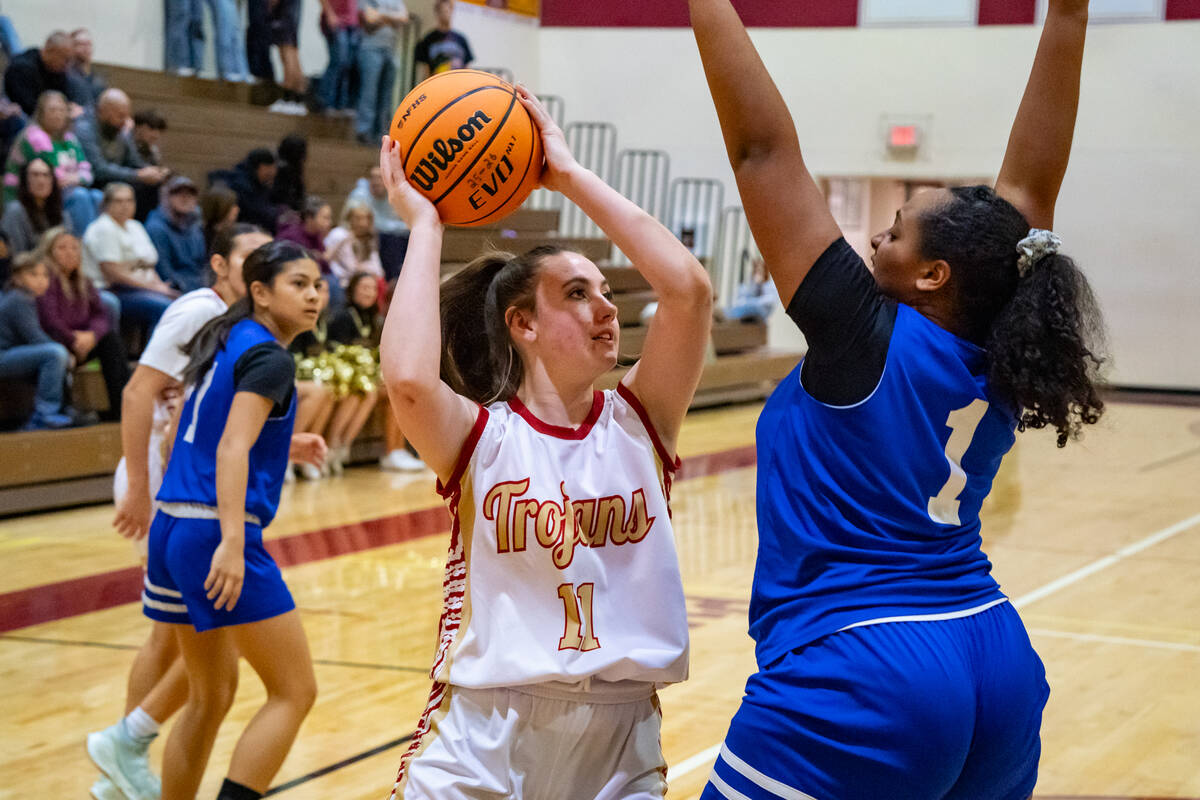 Pahrump Valley High School sophomore Kaitlyn Brown scans the court to find an open girl during ...
