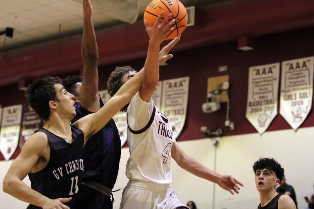 Pahrump Valley High School senior Keir Sheppard is met with hard contact while driving to the h ...