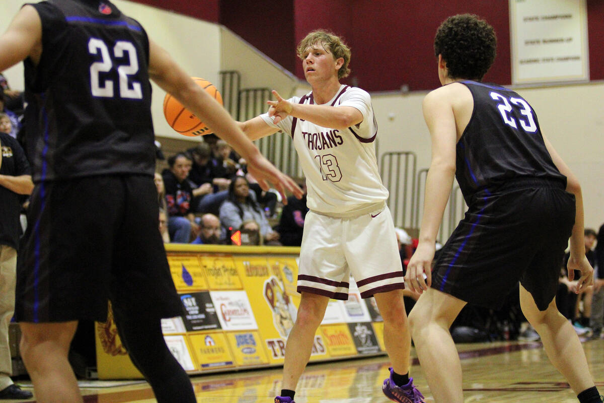 Pahrump Valley High School junior TC Hone throws a pass over to a teammate during the Trojans h ...